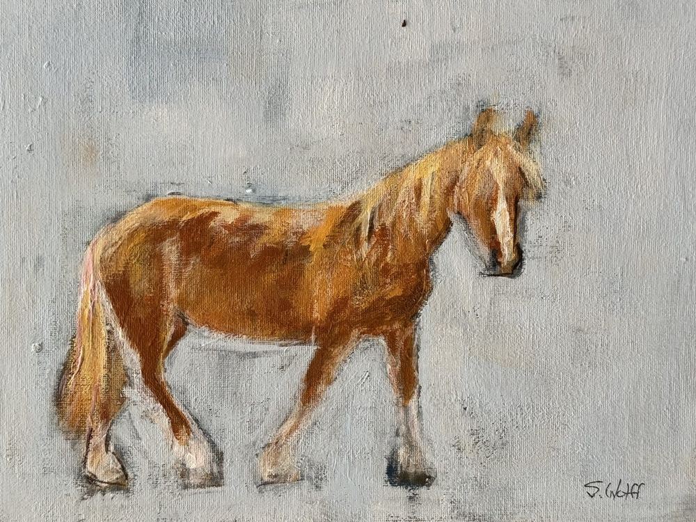 A chestnut horse with a pale mane walking across a gray background